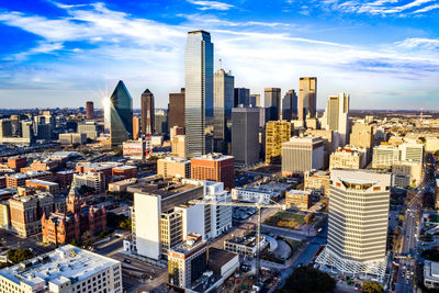 Aerial view of buildings in city against sky