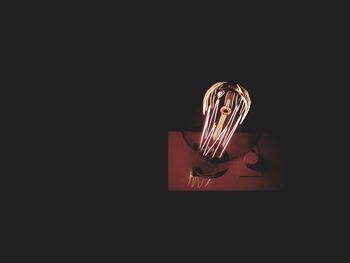 Close-up of electric lamp against black background