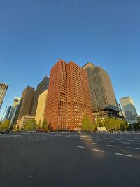 Low angle view of buildings against clear blue sky