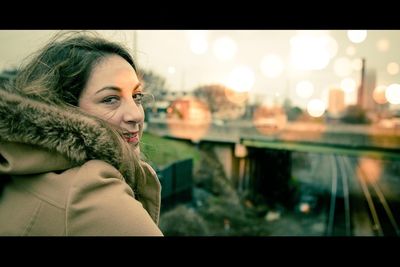 Close-up of woman using mobile phone in city