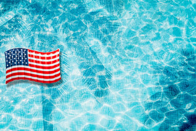 High angle view of flag floating on swimming pool