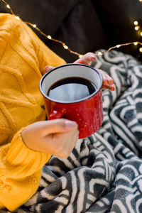 Midsection of woman holding coffee cup