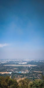 High angle view of townscape against blue sky