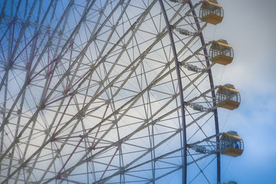 Low angle view of electricity pylon against sky