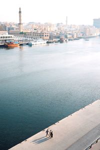 High angle view of buildings by sea against sky