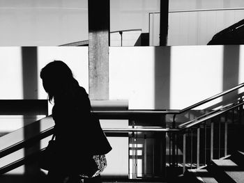 Woman standing against wall