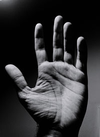 Close-up of hand against black background