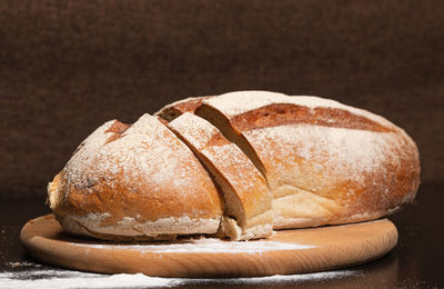 Close-up of bread on table against black background