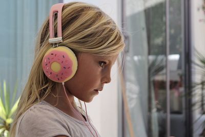 Profile view of girl wearing donut shape headphones