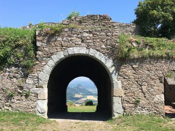 Stone wall with old ruin in the background