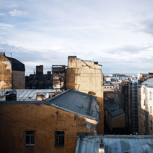 Buildings in city against cloudy sky