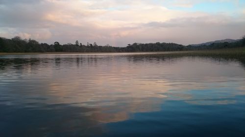 Scenic view of lake against sky at sunset