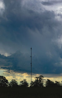 Low angle view of silhouette tower against sky