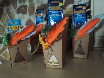 Close-up of multi colored flags hanging on table