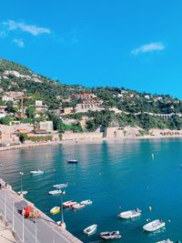 High angle view of townscape by sea against sky