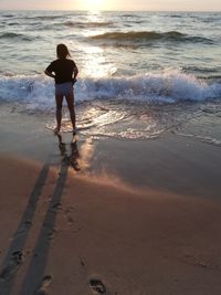 Rear view of man standing on beach