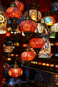 Illuminated lanterns hanging in market for sale