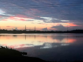 Scenic view of lake against orange sky