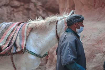 Man walking with horse outdoors