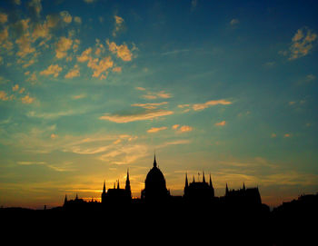Silhouette of building against sky during sunset