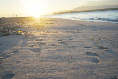 Scenic view of beach against sky during sunset