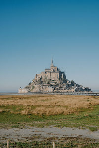 View of temple against clear blue sky