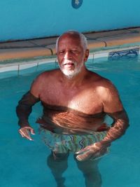 Portrait of shirtless man in swimming pool