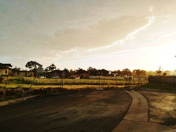 Scenic view of field against sky at sunset