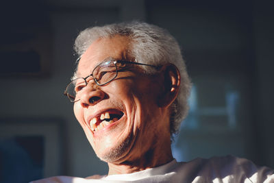 A happy senior asian man at home