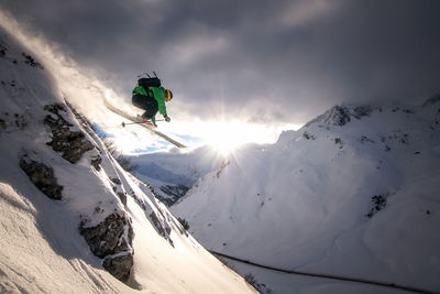 Man skiing on snowcapped mountain