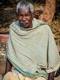 Portrait of a smiling man sitting outdoors