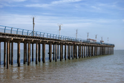 Pier over sea against sky