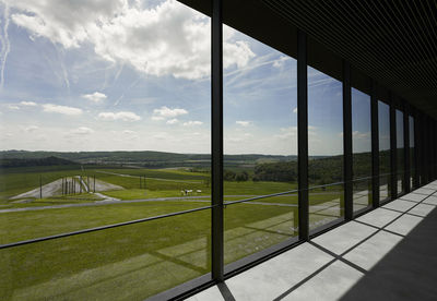 Scenic view of field seen through window