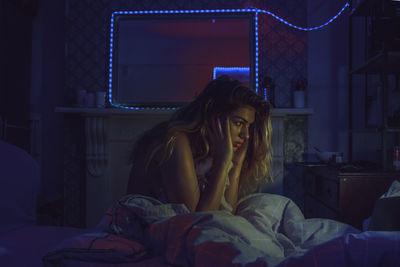 Woman relaxing on bed at home