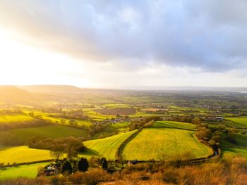 Scenic view of field against cloudy sky