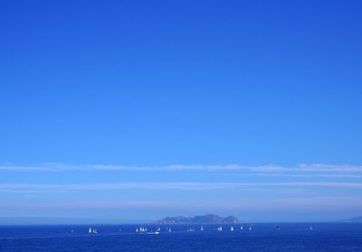 Scenic view of sea against blue sky