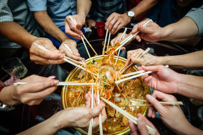 Midsection of friends having food