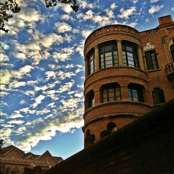 architecture, building exterior, built structure, sky, low angle view, window, cloud - sky, cloud, building, cloudy, residential structure, residential building, day, outdoors, arch, no people, exterior, city, facade, tower