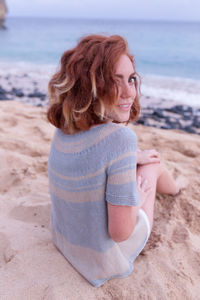 Young woman sitting on beach