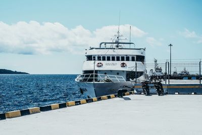 Ship moored on sea against sky