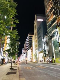 City street amidst buildings at night