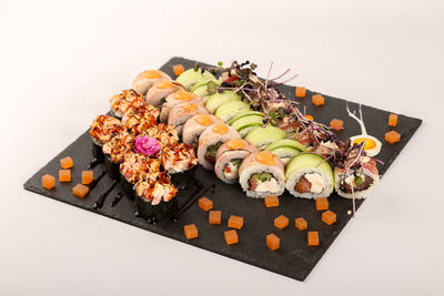 High angle view of sushi on plate against white background