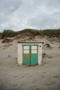 Built structure on beach against sky