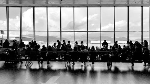 Passengers queuing at the airport waiting the gate. tourists with luggage in queue at the terminal.