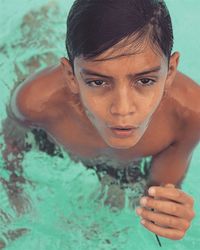 Close-up portrait of young woman swimming in pool