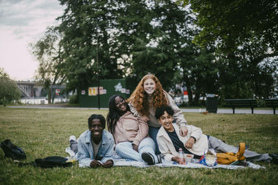 Portrait of multiracial male and female friends at public park
