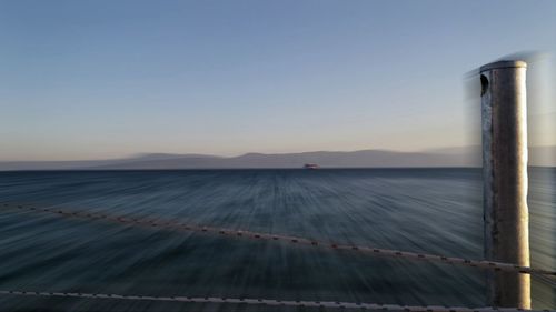 Scenic view of sea against clear sky during sunset