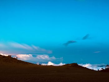 Scenic view of landscape against blue sky