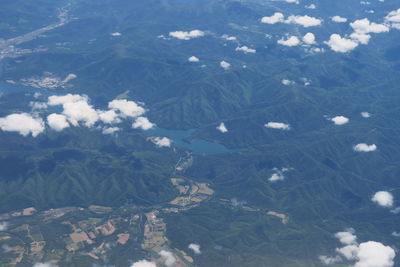 High angle view of land and mountains against sky