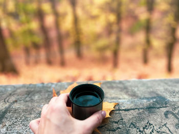 Drinking coffee outdoors in the park is a nice chance to warm up and feel good